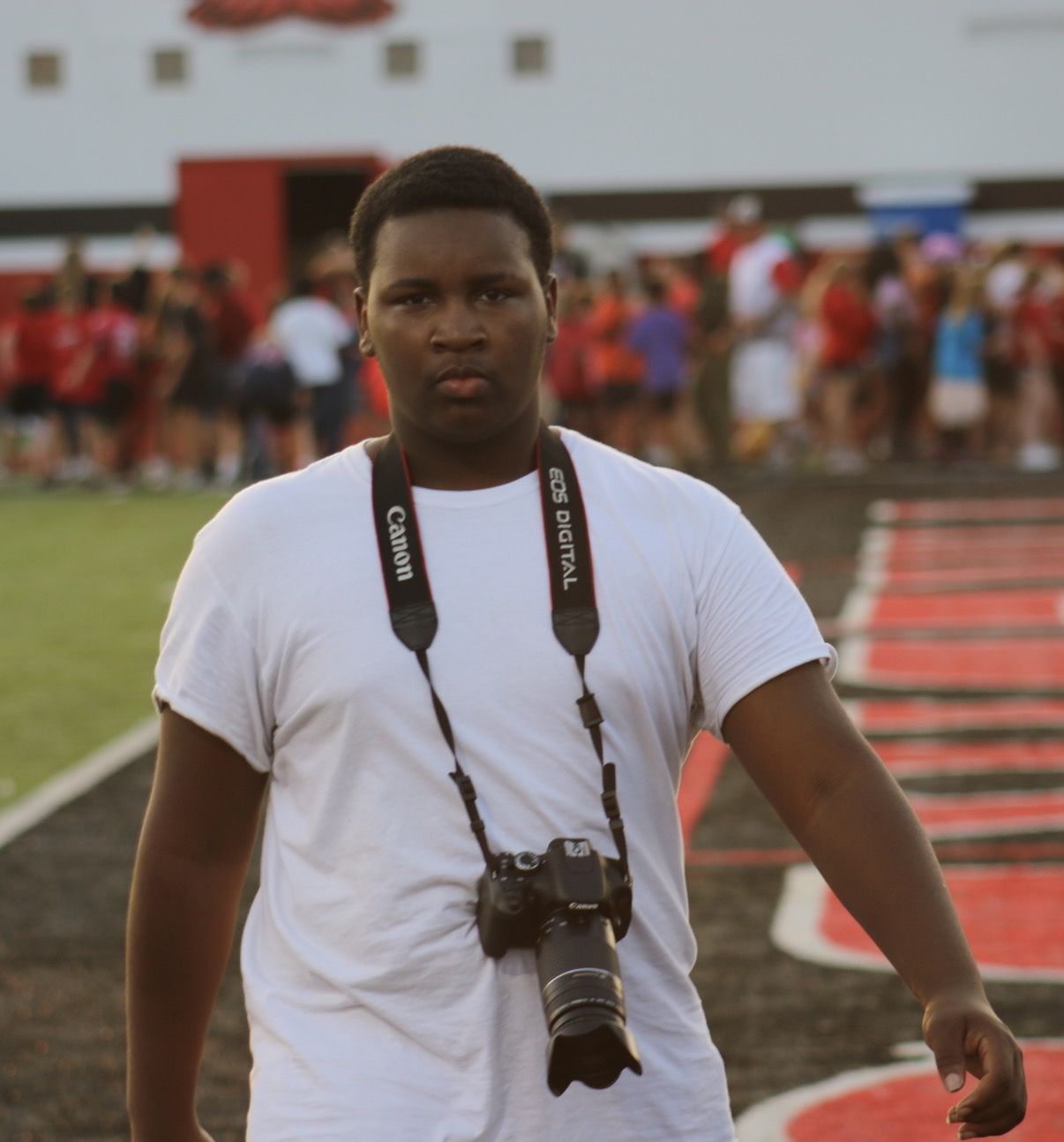 Amarion Mari Harris with a camera at a sports field